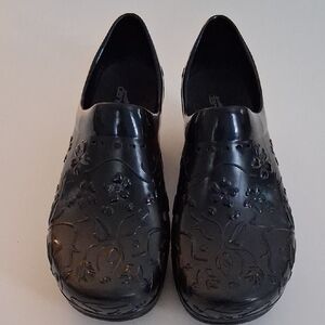 Dansko Black Embossed Floral Clogs
